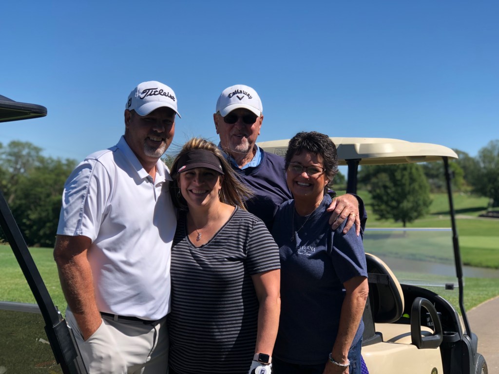 Couples playing golf